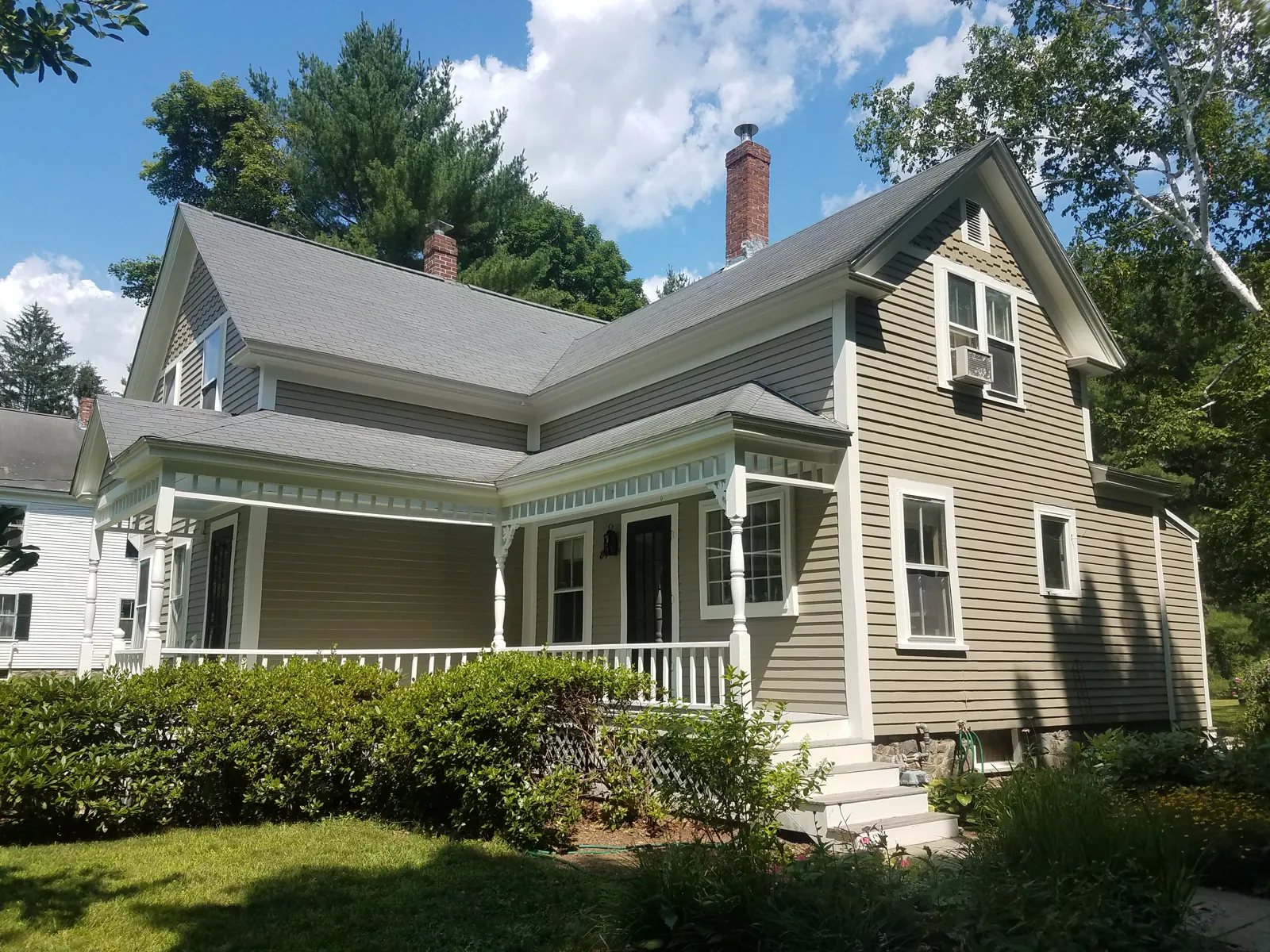 Sage farmhouse with a white porch painted by Beacon